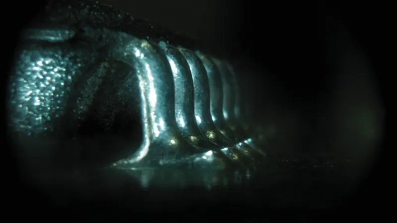 Focus stacking extends depth of field under magnification, enabling clear side-view imaging of BGA solder joints.