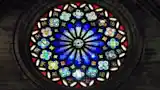 We look at photos by reflecting light on them, while a stained glass window only reveals its beauty when the light shines through it.